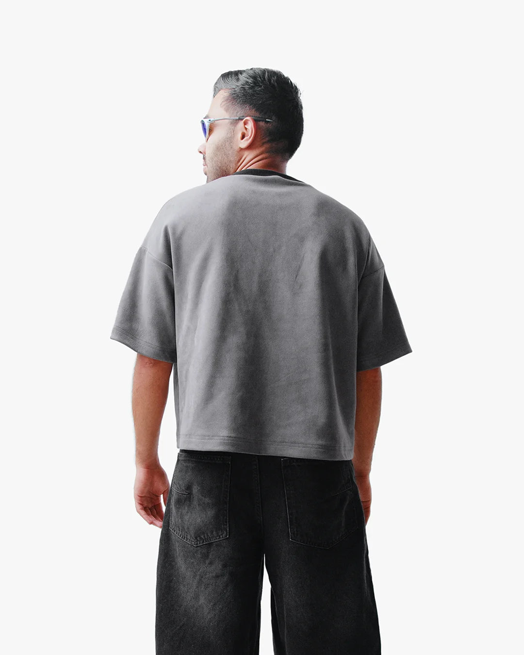 Back view of man wearing Take The Risk Grey vegan fur cropped oversized t-shirt