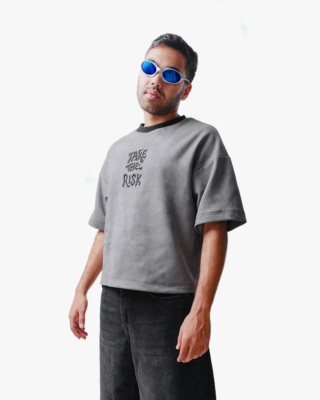 Side view of man wearing Take The Risk Grey vegan fur cropped oversized t-shirt