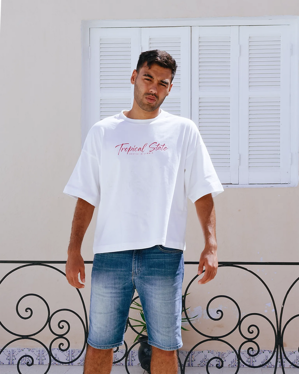 Close-up of TROPICAL STATE™ White cropped oversized T-shirt showing the heavyweight cotton fabric and boxy fit